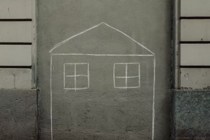 House drawn on brick wall with chalk