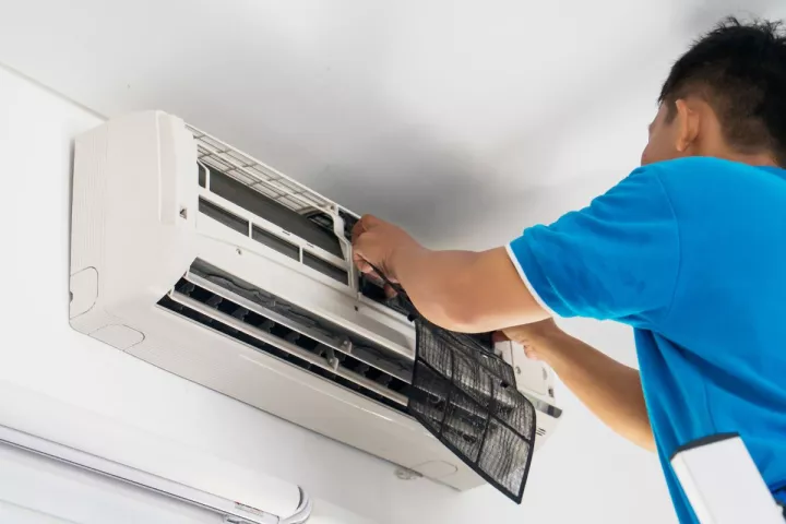 Man repairing air conditioner 