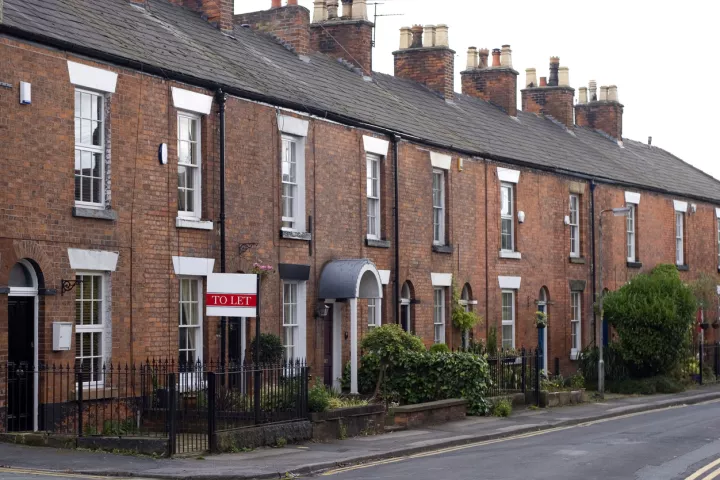 row of terraced houses with a to let sign on one of the houses