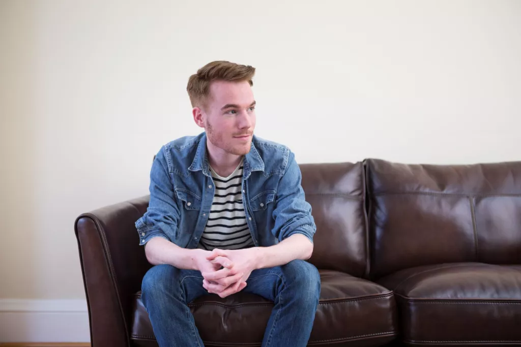 Young man sitting on sofa